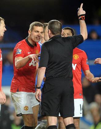 Football - 2013 2014 Premier League - Chelsea FC London vs. Manchester United (ManU) United s Nemanja Vidic is sent off by referee Philip Dowd at Stamford Bridge.