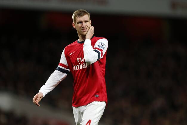 Arsenal s Per Mertesacker looks on dejected Arsenal s vs Manchester United - Premier League - Emirates Stadium - London - England - 12 02 2014 - Pic David Klein Sportimage EDITORIAL USE ONLY. No use with unauthorised audio, video, data, fixture lists, club league logos or live services. Online in-match use limited to 120 images, no video emulation. No use in betting, games or single club league player publications.