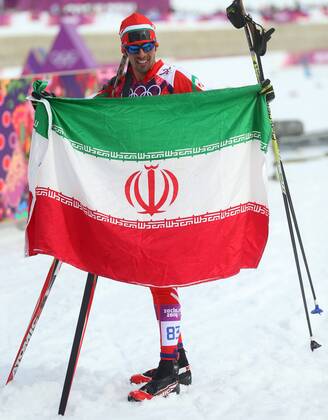 ITAR-TASS: SOCHI, RUSSIA. FEBRUARY 14, 2014. Skier Seyed Sattar Seyd of Iran holds his national flag after the men s cross-country 15 km classic event at the Laura Ski Centre at the 22nd Winter Olympic Games.  premiumd kurios Aufmacher RE139461