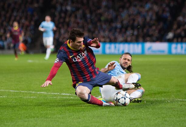 Martin Demichelis of Manchester City brings down Lionel Messi of Barcelona to earn a red card - UEFA Champions League First Knockout Round - Manchester City vs Barcelona - Etihad Stadium - Manchester - England - 18th February 2014 - Picture Phil Oldham Sportimage EDITORIAL USE ONLY. No use with unauthorised audio, video, data, fixture lists, club league logos or live services. Online in-match use limited to 120 images, no video emulation. No use in betting, games or single club league player publications.