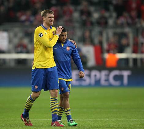 Arsenal s Per Mertesacker looks on dejected at the final whistle with Alex Oxlade Chamberlain Bayern Munich v Arsenal - Champions League last 16 - Allianz Arena - Munich - Germany - 11 03 2014 - Pic DavidKlein Sportimage EDITORIAL USE ONLY. No use with unauthorised audio, video, data, fixture lists, club league logos or live services. Online in-match use limited to 120 images, no video emulation. No use in betting, games or single club league player publications.