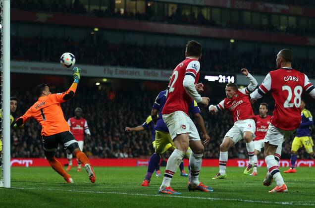 Arsenal s Lukas Podolski scoring his side opening goal Arsenal vs Swansea City - Premier League - Emirates Stadium- London - England - 25 03 2014 - Pic David Klein Sportimage EDITORIAL USE ONLY. No use with unauthorised audio, video, data, fixture lists, club league logos or live services. Online in-match use limited to 120 images, no video emulation. No use in betting, games or single club league player publications.