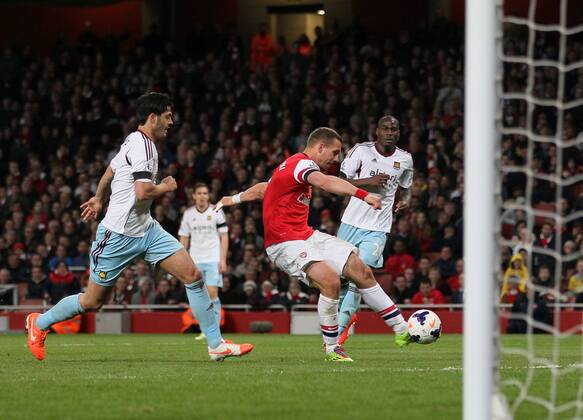 Arsenal s Lukas Podolski scoring his sides third goal Arsenal vs West Ham United- Barclays Premier League - Emirates Stadium - London - England - 15 04 2014 - Pic David Klein Sportimage EDITORIAL USE ONLY. No use with unauthorised audio, video, data, fixture lists, club league logos or live services. Online in-match use limited to 120 images, no video emulation. No use in betting, games or single club league player publications.