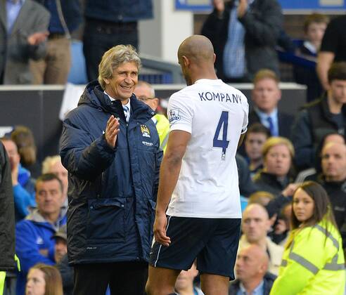 Manuel Pellegrini manager of Manchester City celebrates with his captain Vincent Kompany of Manchester City - Barclays Premier League - Everton v Manchester City - Goodison Park Stadium - Liverpool - England - 3rd May 2014 - Pic Simon Bellis Sportimage EDITORIAL USE ONLY. No use with unauthorised audio, video, data, fixture lists, club league logos or live services. Online in-match use limited to 120 images, no video emulation. No use in betting, games or single club league player publications.