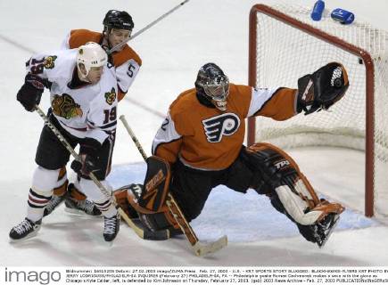 Feb. 27, 2003 - U.S. - KRT SPORTS STORY SLUGGED: BLACKHAWKS-FLYERS KRT PHOTO BY JERRY LODRIGUSS PHILADELPHIA INQUIRER (February 27) PHILADELPHIA, PA -- Philadelphia goalie Roman Cechmanek makes a save with the glove as Chicago s Kyle Calder, left, is defended by Kim Johnsson on Thursday, February 27, 2003. (gsb) 2003 News Archive - Feb. 27, 2003 - ZUMAm67