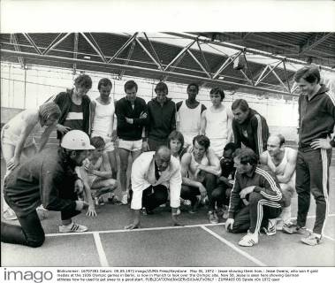 May 05, 1972 - Jesse showing them how.: Jesse Owens, who won 4 gold medals at the 1936 Olympic games in Berlin, is now in Munich to look over the Olympic site. Now 58, Jesse is seen here showing German athletes how he used to get sway to a good start.  - ZUMAk09