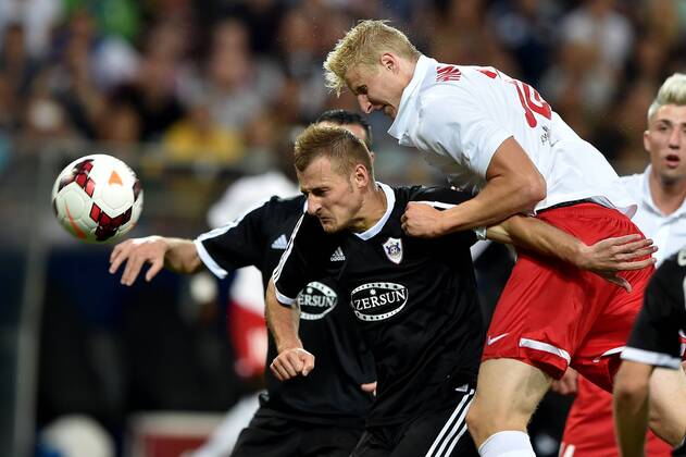 SOCCER - CL, RBS vs Qarabag SALZBURG,AUSTRIA,06.AUG.14 - SOCCER - UEFA Champions League, qualifying, Red Bull Salzburg vs Qarabag Agdam FK. Image shows Ansi Agolli (Qarabag) and Martin Hinteregger (RBS).
