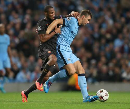 Seydou Keita of Roma challenges Edin Dzeko of Manchester City - UEFA Champions League group E - Manchester City vs Roma - Etihad Stadium - Manchester - England - 30th September 2014 - Picture Simon Bellis Sportimage EDITORIAL USE ONLY. No use with unauthorised audio, video, data, fixture lists, club league logos or live services. Online in-match use limited to 120 images, no video emulation. No use in betting, games or single club league player publications.