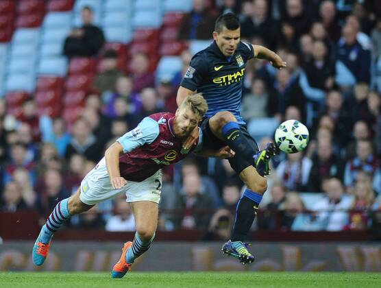 Football - 2014 2015 Premier League - Aston Villa vs. Manchester City City s Sergio Kun Agüero and Nathan Baker at Villa Park. COLORSPORT ANDREWxCOWIE