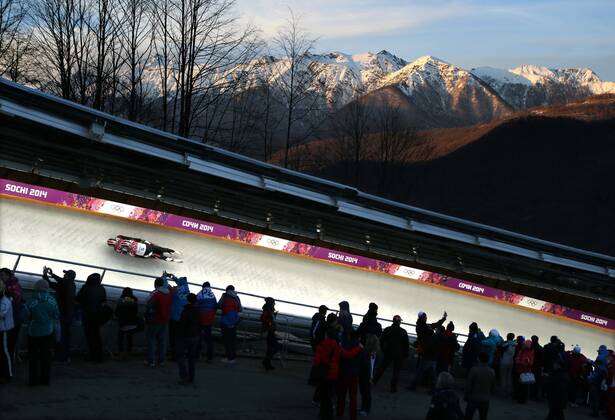 February 12, 2014 - Sochi, Russia - CHRISTIAN NICCUM and JAYSON TERDIMAN of the USA, cruises around a turn to an 11th place finish in Men s Luge Doubles, as the sun sets on the Caucasus Mountains at the Sanki Sliding Center at the 2014 Sochi Winter Olympics. Rocky Mountain High  - ZUMASoch