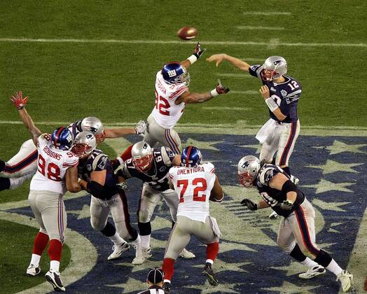 Feb. 3, 2008 - New England Patriots quarterback Tom Brady makes a pass over the pressure of the New York Giants Michael Strahan (92) in the third qurter of Super Bowl XLII at University of Phoenix Stadium in Glendale, Arizona, on Sunday, February 3, 2008. (Mark Cornelison MCT) News Archive - Feb. 3, 2008 - ZUMAm67_