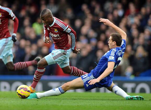 Football - 2014 2015 Premier League - Chelsea vs. West Ham United West ham s Enner Valencia rides the tackle of Nemanja Matic at Stamford Bridge. COLORSPORT ANDREW COWIE