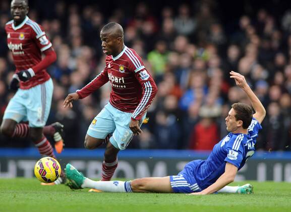 Football - 2014 2015 Premier League - Chelsea vs. West Ham United West ham s Enner Valencia rides the tackle of Nemanja Matic at Stamford Bridge. COLORSPORT ANDREW COWIE