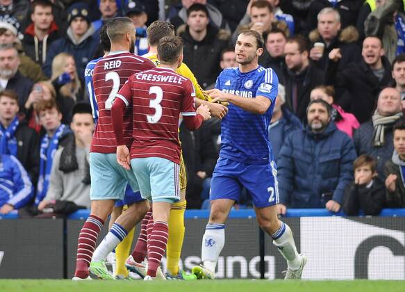 Football - 2014 2015 Premier League - Chelsea vs. West Ham United Chelsea s Branislav Ivanovic is challenged by West ham players, accusing him of diving at Stamford Bridge. COLORSPORT ANDREW COWIE