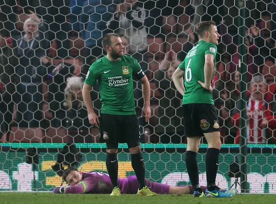Jon Platt, Neil Ashton and Joe Clarke of Wrexham dejected as Stoke players celebrate- FA Cup Third Round - Stoke City vs Wrexham - Britannia Stadium - Stoke on Trent - England - 4th January 2015 - Picture Simon Bellis Sportimage EDITORIAL USE ONLY. No use with unauthorised audio, video, data, fixture lists, club league logos or live services. Online in-match use limited to 120 images, no video emulation. No use in betting, games or single club league player publications.