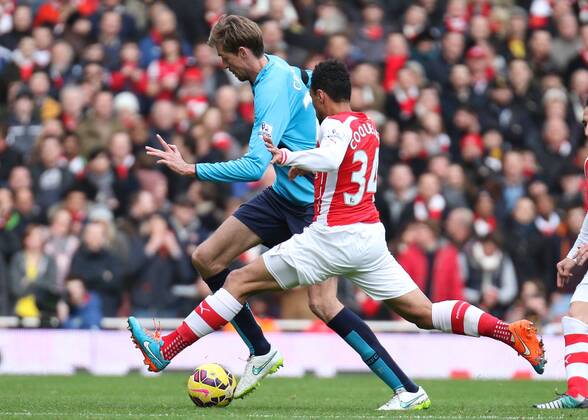 Football - 2014 2015 - Barclays Premier League, - Arsenal Vs Stoke City, Arsenal s Francis Coquelin stretches into the tackle with Stoke City s Peter Crouch at The Emirates Stadium COLORSPORT DANIEL BEARHAM ARS_STO