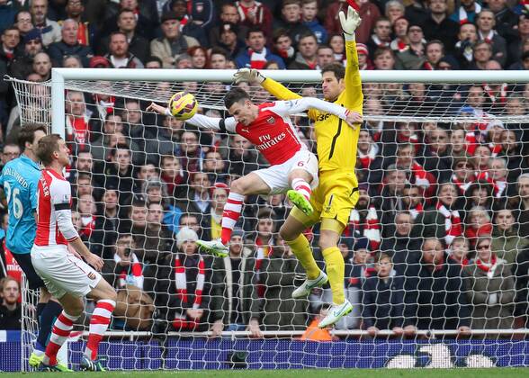 Football - 2014 2015 - Barclays Premier League, - Arsenal Vs Stoke City, Arsenal s Laurent Koscielny tries to head covered by Stoke City s Asmir Begovic at The Emirates Stadium COLORSPORT DANIEL BEARHAM ARS_STO