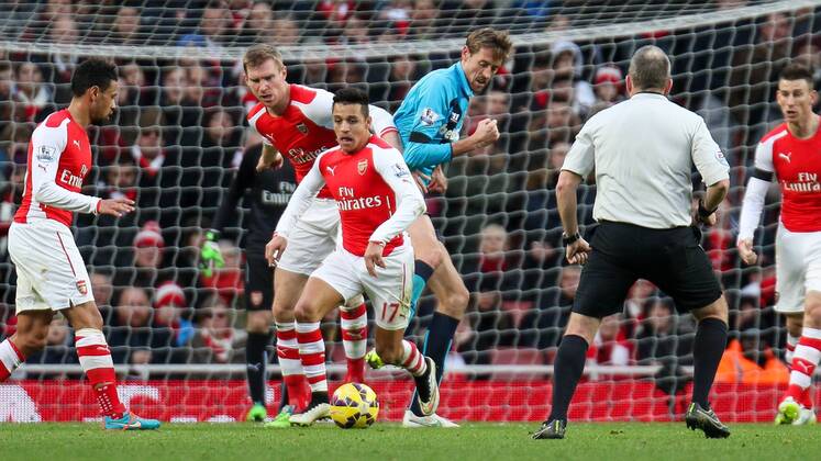 Football - 2014 2015 - Barclays Premier League, - Arsenal Vs Stoke City, Arsenal s Alexis Sanchez nips in front of Stoke City s Peter Crouch and Arsenal s Per Mertesacker to steal the ball at The Emirates Stadium  ARS_STO