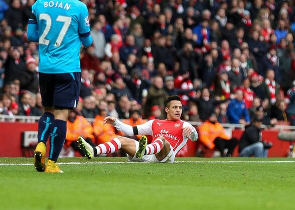 Football - 2014 2015 - Barclays Premier League, - Arsenal Vs Stoke City, Arsenal s Alexis Sanchez appeals to the referee after being upended at The Emirates Stadium ARS_STO
