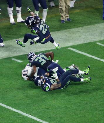 01 February 2015: New England Patriots tight end Rob Gronkowski 87 is brought down by Seattle Seahawks cornerback Richard Sherman 25 (top) strong safety Kam Chancellor 31 (middle) and free safety Earl Thomas 29 (bottom) during the second half of Super Bowl XLIX between the Seattle Seahawks and the New England Patriots at University of Phoenix Stadium in Glendale, Az. The New England Patriots beat the Seattle Seahawks 28-24. NFL American Football Herren USA FEB 01 Super Bowl XLIX - Patriots v Seahawks Icon3171502012930 EDITORIAL USE ONLY