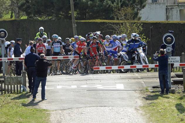 - ROUBAIX, FRANCE: Riders are blocked at a rail barrier at the Paris-Roubaix one day cycling race, 253,5 km from Compiegne to the Velodrome in Roubaix, Sunday 12 April 2015. DIRKxWAEM  x04603019x