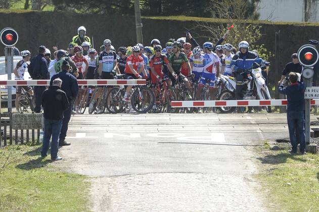 - ROUBAIX, FRANCE: Illustration picture shows the pack of riders passing a closed railroad crossing during the Paris-Roubaix one day cycling race, 253,5 km from Compiegne to the Velodrome in Roubaix, Sunday 12 April 2015. DIRKxWAEM  x04603426x