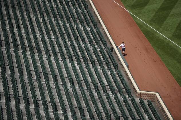 A ballgirl waits as the Baltimore Orioles play the Chicago White Sox at Orioles Park at Camden Yards, in Baltimore, Maryland on April 29, 2015. For the first time in Major League Baseball s history fans were not allowed to the game because of the ongoing civil unrest and protest in Baltimore in the wake of Freddie Gray s death. The late 25-year-old died earlier this month from a spinal injury while in police custody.  BAL20150429320 KEVINxDIETSCH