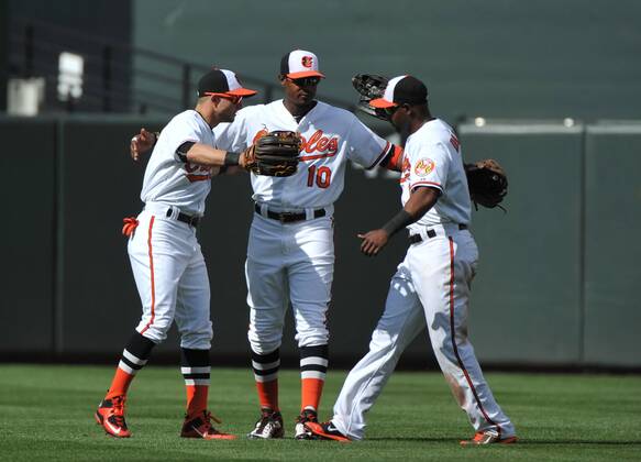 Baltimore Orioles outfielders Adam Jones (10) Delmon Young (R) and Alejandro De Aza hug after the Orioles 8-2 win over the Chicago White Sox at Orioles Park at Camden Yards in Baltimore, Maryland on April 29, 2015. For the first time in Major League Baseball s history fans were not allowed to the game because of the ongoing civil unrest and protest in Baltimore in the wake of Freddie Gray s death. The late 25-year-old died earlier this month from a spinal injury while in police custody.  BAL20150429329 KEVINxDIETSCH