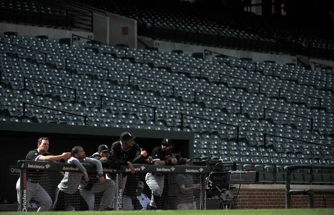 Members of the Chicago White Sox are seen in the dugout as they play the Baltimore Orioles at Orioles Park at Camden Yards in Baltimore, Maryland on April 29, 2015. For the first time in Major League Baseball s history fans were not allowed to the game because of the ongoing civil unrest and protest in Baltimore in the wake of Freddie Gray s death. The late 25-year-old died earlier this month from a spinal injury while in police custody.  BAL20150429331 KEVINxDIETSCH