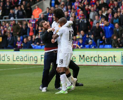 Manchester United ManU s Marouane Fellaini celebrates scoring his sides second goal as fans invade the pitch Barclays Premier League - Crystal Palace vs Manchester United- Selhurst Park - England - 9th May 2015 - Picture David Klein Sportimage EDITORIAL USE ONLY. No use with unauthorised audio, video, data, fixture lists, club league logos or live services. Online in-match use limited to 120 images, no video emulation. No use in betting, games or single club league player publications.