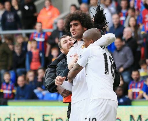 Manchester United ManU s Marouane Fellaini celebrates scoring his sides second goal as fans invade the pitch Barclays Premier League - Crystal Palace vs Manchester United- Selhurst Park - England - 9th May 2015 - Picture David Klein Sportimage EDITORIAL USE ONLY. No use with unauthorised audio, video, data, fixture lists, club league logos or live services. Online in-match use limited to 120 images, no video emulation. No use in betting, games or single club league player publications.