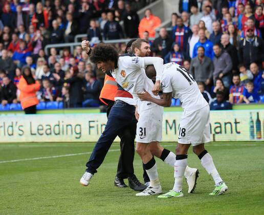 Manchester United ManU s Marouane Fellaini celebrates scoring his sides second goal as fans invade the pitch Barclays Premier League - Crystal Palace vs Manchester United- Selhurst Park - England - 9th May 2015 - Picture David Klein Sportimage EDITORIAL USE ONLY. No use with unauthorised audio, video, data, fixture lists, club league logos or live services. Online in-match use limited to 120 images, no video emulation. No use in betting, games or single club league player publications.