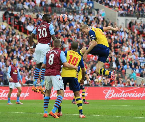 Arsenal s Per Mertesacker scoring his sides third goal FA Cup Final - Arsenal vs Aston Villa - Wembley Stadium - England - 30th May 2015 - Picture David Klein Sportimage EDITORIAL USE ONLY. No use with unauthorised audio, video, data, fixture lists, club league logos or live services. Online in-match use limited to 120 images, no video emulation. No use in betting, games or single club league player publications.