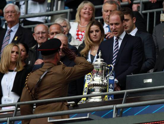 The FA Cup Final - Arsenal v Aston Villa . . London, UK . . 30.05.2015 A soldier salutes Aston Villa fan Prince William, Duke of Cambridge, after delivering the FA Cup.