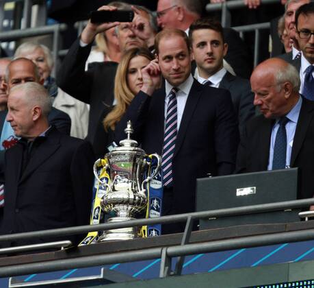 The FA Cup Final - Arsenal v Aston Villa . . London, UK . . 30.05.2015 Aston Villa fan Prince William, Duke of Cambridge, tries to avoid looking at the Arsenal ribbons on the FA Cup.