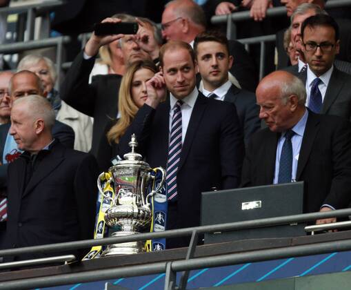 The FA Cup Final - Arsenal v Aston Villa . . London, UK . . 30.05.2015 Aston Villa fan Prince William, Duke of Cambridge, tries to avoid looking at the Arsenal ribbons on the FA Cup.