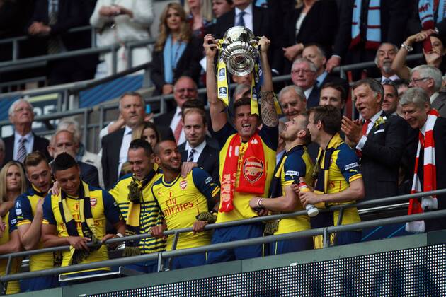 The FA Cup Final - Arsenal v Aston Villa . . London, UK . . 30.05.2015 Olivier Giroud (A) celebrates with the FA Cup, beside Theo Walcott (A) and with Aston Villa fan Prince William, Duke of Cambridge behind.