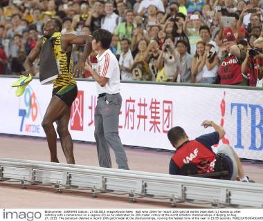 Bolt wins 200m for record 10th gold at worlds Usain Bolt (L) stands up after colliding with a cameraman on a segway (R) as he celebrated his 200-meter victory at the world athletics championships in Beijing on Aug. 27, 2015. The Jamaican claimed a record 10th gold medal at the championships, running the fastest time of the year in 19.55 seconds.
