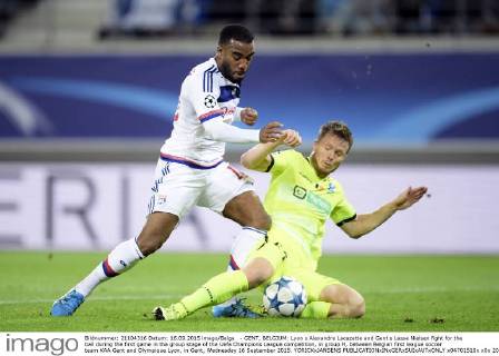 - GENT, BELGIUM: Lyon s Alexandre Lacazette and Gent s Lasse Nielsen fight for the ball during the first game in the group stage of the Uefa Champions League competition, in group H, between Belgian first league soccer team KAA Gent and Olympique Lyon, in Gent, Wednesday 16 September 2015. YORICKxJANSENS x04701510x