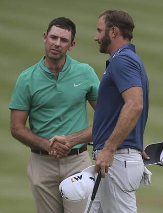 July 3, 2016 - Akron, OH, USA - Winner Dustin Johnson, right, shakes hands with Charl Schwartzel, who finished tied for seventh, on the 18th hole on the final day of the Bridgestone Invitational golf tournament on Sunday, July 3, 2016, at Firestone Country Club in Akron, Ohio. Bridgestone Invitational - ZUMAm67_