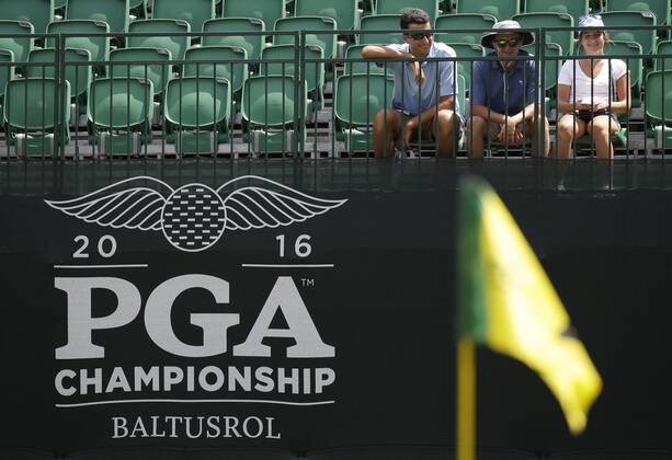 Fans sit in the empty stands to watch a practice round at the PGA Golf Herren Championship at Baltusrol Golf Club in Springfield, New Jersey on July 26, 2016.  PGA20160726113 JOHNxANGELILLO