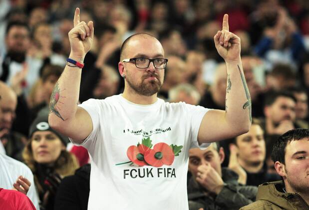 Football - 2016 2017 World Cup Qualifier - Group F: England vs. Scotland England fan with a message to FIFA over the wearing of a poppy at Wembley. COLORSPORT ANDREW COWIE 