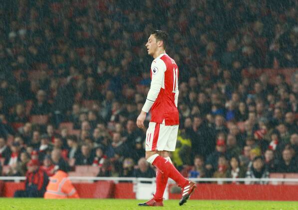 Arsenal v Stoke City . . London, UK . . 10.12.2016 Mesut Ozil (A) in the pouring rain.