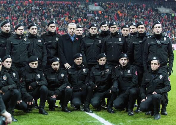 Turkish President Recep Tayyip Erdogan poses with the Turkish polices before a friendly football match held for the martyrs killed on the recent terror attacks in Turkey, at Vodafone Arena in Istanbul, Turkey on December 22, 2016. Foreign and Turkish footballers from Turkish Spor Toto Super League s 18 team, compete at the friendly match and the income of the match will be donated to relatives of the martyrs. Copyright: TolgaxAdanali 15587379