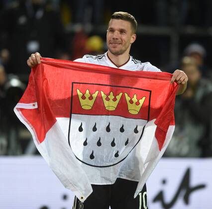 Fußball-Länderspiel: Deutschland - England 22.03.2017 in Dortmund. Lukas Podolski (Deut.) auf der Ehrenrunde mit Köln-Fahne. HM