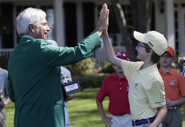 Freddie Couples high fives Liam Hartling who is the overall winner of the Boys 10-11 age group in the Drive, Chip & Putt Championship at the 2017 Masters Tournament at Augusta National Golf Club in Augusta, Georgia on April 2, 2017.  AUG20170402119 JOHNxANGELILLO