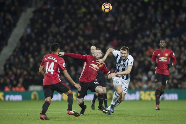 Wayne Rooney of Manchester United ManU tussles with Gareth McAuley of West Bromwich Albion during the Premier League match between West Bromwich Albion and Manchester United at The Hawthorns, West Bromwich, England on 17 December 2016. Copyright: xDarrenxMusgrovex 13430054