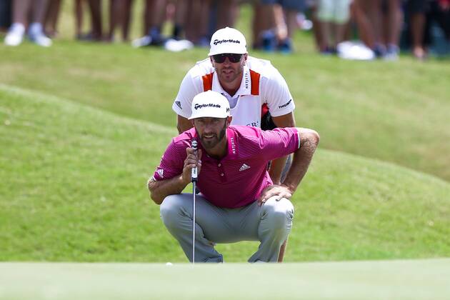 May 12, 2017 - Ponte Vedra Beach, Florida, United States - Dustin Johnson (bottom) and his caddie Austin Johnson line up a putt on the 9th green during the second round of The PLAYERS Championship at TPC Sawgrass. Golf 2017: The PLAYERS Championship - Round 2 - ZUMAw109 20170512_zap_w109_006 Copyright: xDebbyxWongx