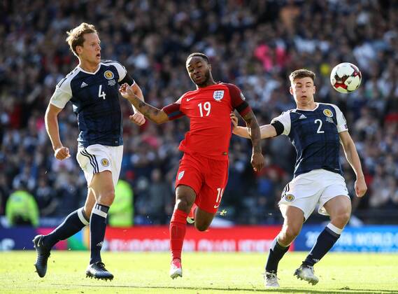 Scotland s Christophe Berra and Kieran Tierney tussle with England s Raheem Sterling during the FIFA World Cup WM Weltmeisterschaft Fussball Qualifying match at Hampden Park Stadium, Glasgow Picture date 10th June 2017. Picture credit should read: David Klein Sportimage EDITORIAL USE ONLY. No use with unauthorised audio, video, data, fixture lists, club league logos or live services. Online in-match use limited to 120 images, no video emulation. No use in betting, games or single club league player publications.