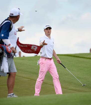 Justin Thomas tosses his ball to his caddie after making a birdie putt on the 8th hole during round 3 of the 117th U.S. Open golf tournament at Erin Hill golf course on June 17, 2017 in Erin, Wisconsin.  WIS20170617101 BRIANxKERSEY